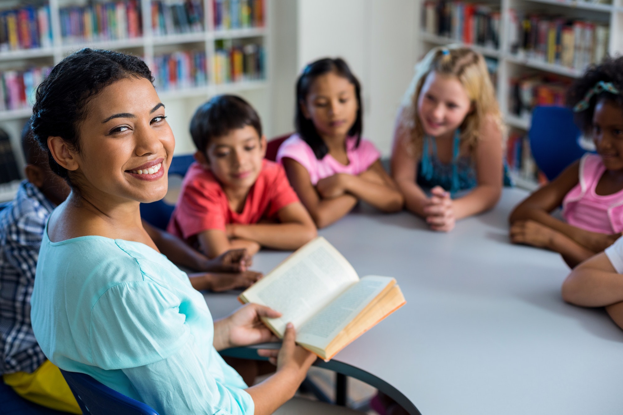 Pupils listening to their teacher reading